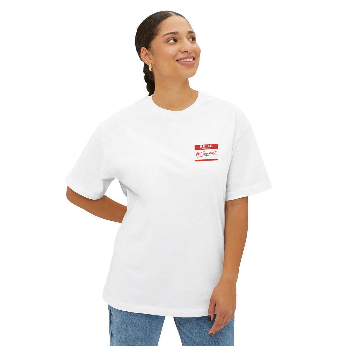 Person wearing a white t-shirt with a red and white name tag on a white background